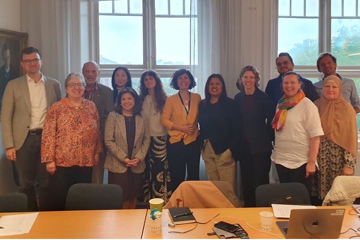 Photograph of researchers standing by table.